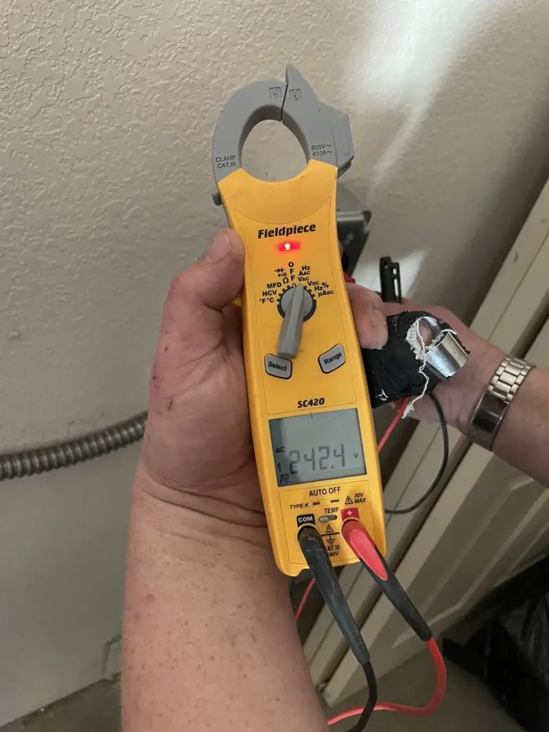 Voltage testing with clamp meter during Ceiling Fan Installation in Utica